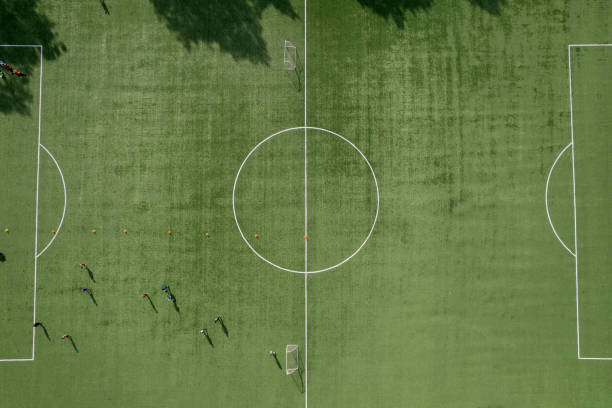istock drone view of artificial turf football field, training process. reserve field 1432289684