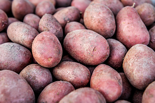 Texture of organic potatoes with red peel