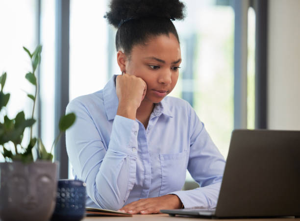 istock Serious, frustrated and thinking while waiting and working on a laptop with slow internet or wifi connection in an office. Black female entrepreneur looking worried about mistake or glitch online 1432290049