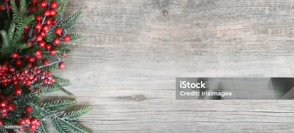 Christmas and New Year Holiday Evergreen Fir Branches and Red Winter Berries Over Wood Panoramic Background Shot from Above Christmas and New Year Holiday Evergreen Fir Branches and Red Winter Berries Over Wood Panoramic Background Shot from Directly Above with Copy Space Holiday - Event Stock Photo