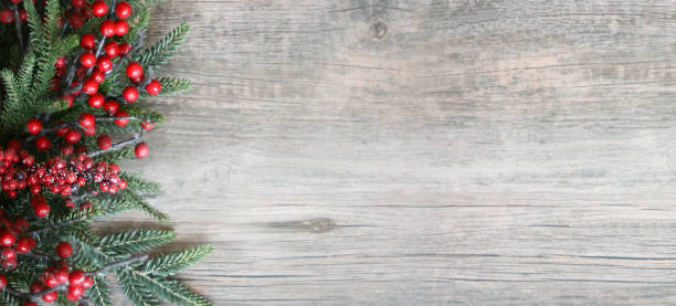 Christmas and New Year Holiday Evergreen Fir Branches and Red Winter Berries Over Wood Panoramic Background Shot from Above Christmas and New Year Holiday Evergreen Fir Branches and Red Winter Berries Over Wood Panoramic Background Shot from Directly Above with Copy Space evergreen garland stock pictures, royalty-free photos & images