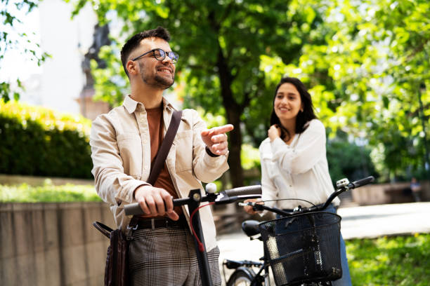 istock Happy funny couple with bicycle in the park. 1432296194