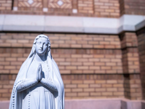 istock Mother Mary with prayer hands statue 1432300215