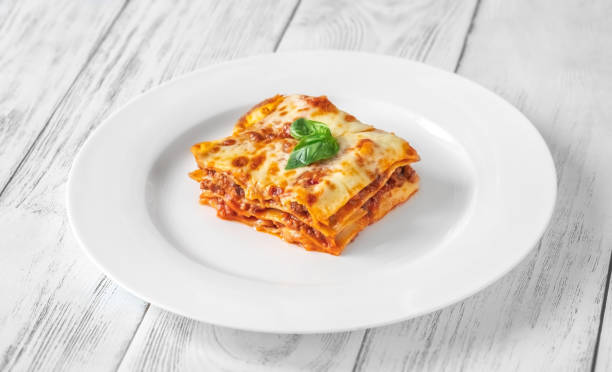 istock Portion of lasagne on white plate 1432300500