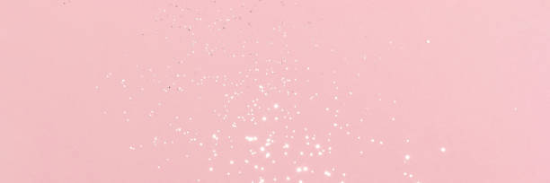 istock Sparkling silver glitter on pink background banner 1432302534