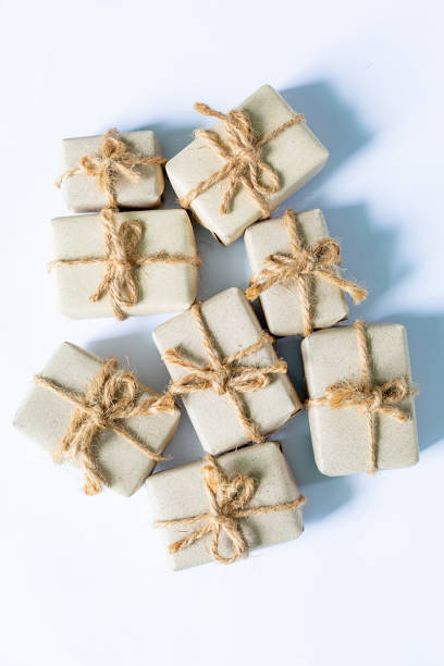 istock gift on a white background,Brown paper package with red gift tag in row of plain ones 1432306401