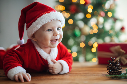 Little baby boy wearing a santa claus costume.Christmas holiday