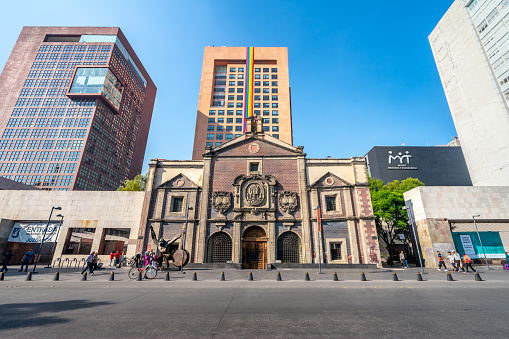Mexico, Mexico City - June 4, 2022: Memory and Tolerance Museum in front of The Benito Juárez Hemicycle monument and Alameda Central.