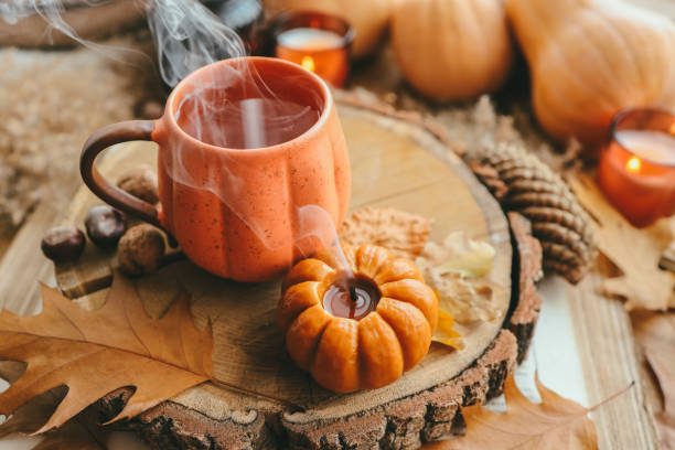 istock Smoke from an extinguished candle and a cup of tea, autumn composition 1432310203