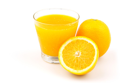 Assorted citrus fruits juice as Orange juice, lemonande and mandarine juice on rustic wood table background with assorted citrus fruits in a wood crate tray