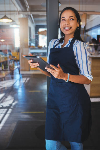 istock Startup, management and cafe owner online order on digital tablet doing inventory, happy and checking stock. Smiling woman enjoying her job, looking proud and ambitious at a new small business 1432310826