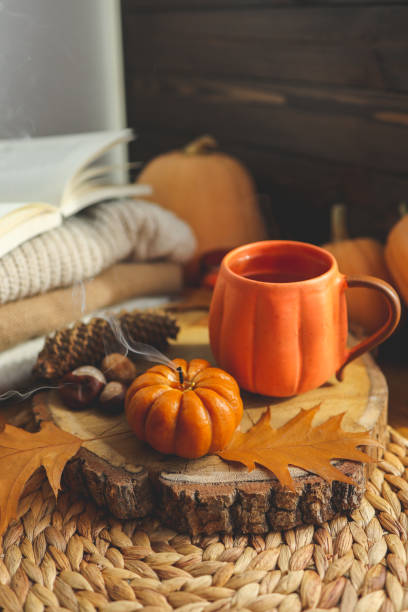 istock Smoke from an extinguished candle and a cup of tea, autumn composition 1432310937