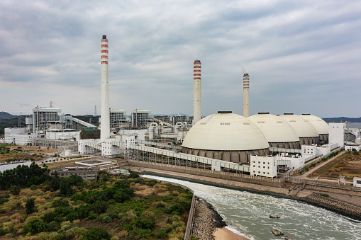 Seaside thermal power plant under overcast weather