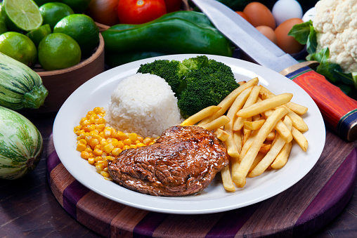 Grilled steak, rice, french fries, broccoli and corn