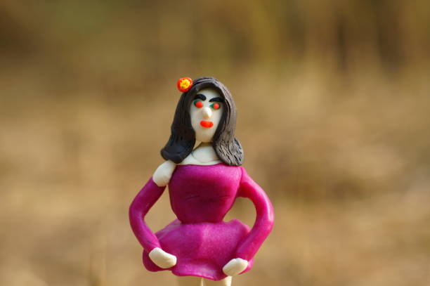 Vampire figurine made of plasticine on a colored background.