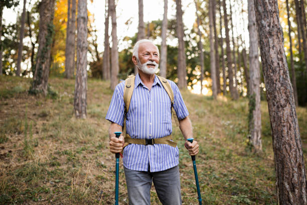 istock Senior man using hiking poles on a hike 1432319634