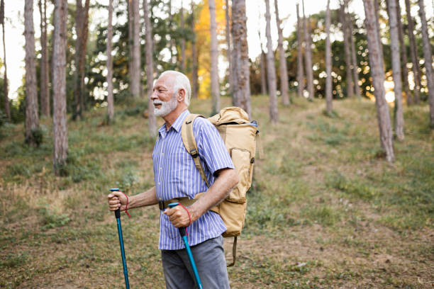 istock Senior man using hiking poles on a hike 1432319806