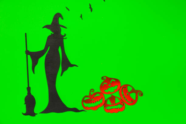 Silhouette of witch and pumpkin-headed boy under the red dazzling sun looked mysterious and terrifying.