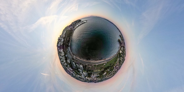 A tiny planet aerial view of the resort of Torquay at sunrise in Devon, UK