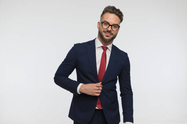 istock happy bearded man with glasses fixing and unbuttoning suit 1432325992
