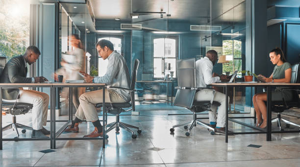 istock Coworking space, office and sharing desk in corporate workplace. Diversity, efficiency and modern working environment for inclusive company. Start up and motion blur of fast and busy employees 1432327351