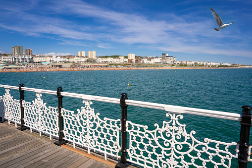 Brighton seaside resort beach and Brighton Palace Pier in a summer sunny blue sky day with tourists in UK, Great Britain, England in East Sussex 47 miles south London, called as \