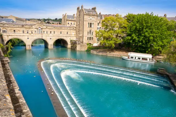 Bath Pulteney Bridge Poulteney over River Avon in the county of Somerset, England UK. Bath became popular as a spa town with the Roman Baths thanks to hot springs.
