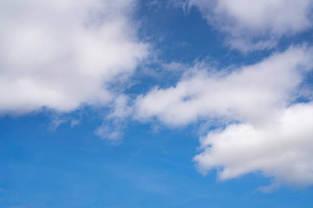 White cumulus clouds in a blue summer sky background
