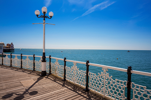 Brighton seaside resort beach and Brighton Palace Pier in a summer sunny blue sky day in UK, Great Britain, England in East Sussex.