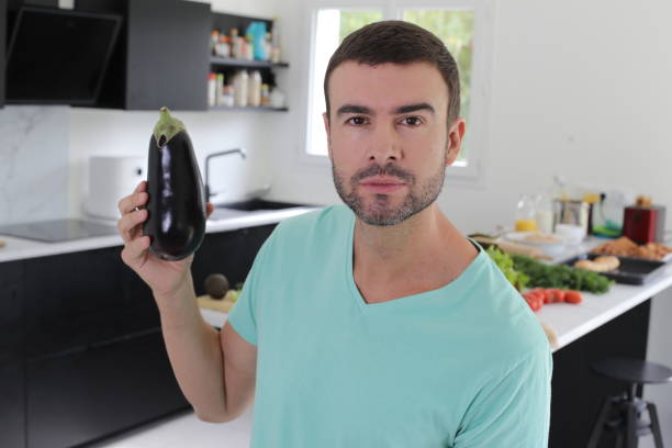 istock Man holding a delicious eggplant 1432334168