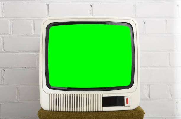 istock An old white TV from the 90s with a green screen against a brick wall. Retro technology concept. 1432334670