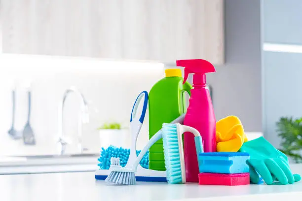 Cleaning concepts: multicolored household cleaning products and tools shot on kitchen counter. Selective focus on products. High resolution 42Mp indoors digital capture taken with Sony A7rII and Sony FE 90mm f2.8 macro G OSS lens