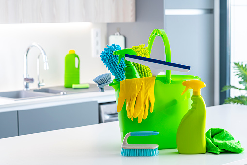 Green and yellow household cleaning products shot on kitchen island. Selective focus on products. High resolution 42Mp indoors digital capture taken with Sony A7rII and Sony FE 90mm f2.8 macro G OSS lens