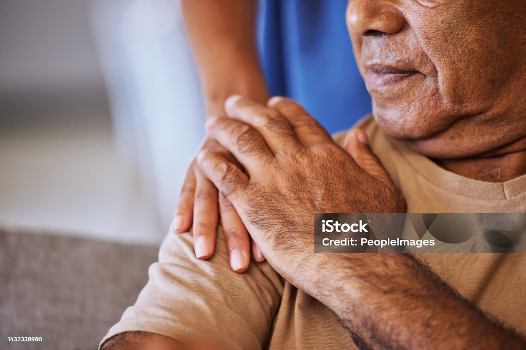Support, care and helping hands for an elderly patient during a consultation at a nursing clinic. Closeup of hope, trust and comfort from a woman caregiver consulting a senior man in retirement home Hospice Stock Photo