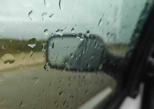 rain drops on the glass, rainy day inside the car, storm, wet car rear view