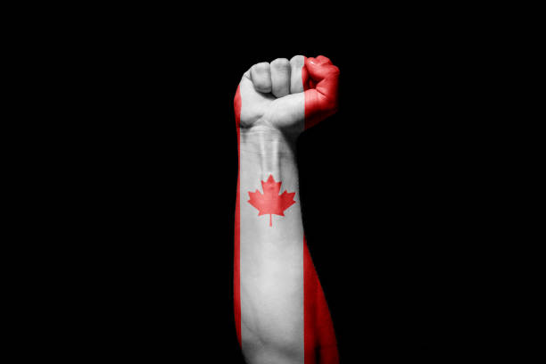 istock Man's hand in a fight signal with the countries flag. 1432339536