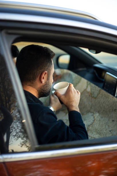 istock Driver uses navigation on his mobile phone in the car 1432339691