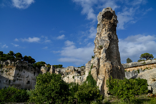 Syracuse, Sicily, Italy:
Latomia of Paradise. 
The ancient limestone quarry, now a lush garden that houses the famous caves, provided, in Greek times, no less than 850,000 cubic meters of limestone blocks.