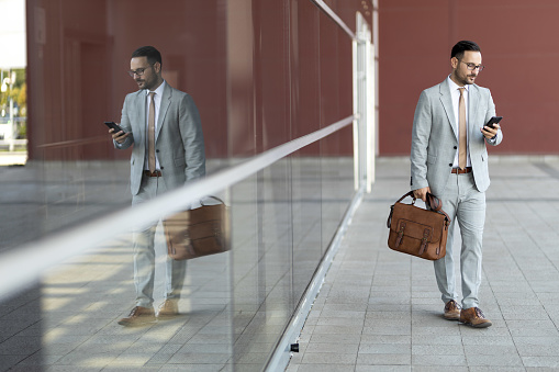 Portrait of a young businessman holding phoneBusiness stock photo
Reflection in glass
