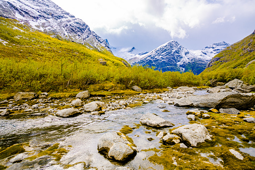 Mountain river. Picturesque landscape in Norway. Beautiful north nature. Scandinavia. Adventure in mountains. Norwegian climate. Snow on mountain. Glacier