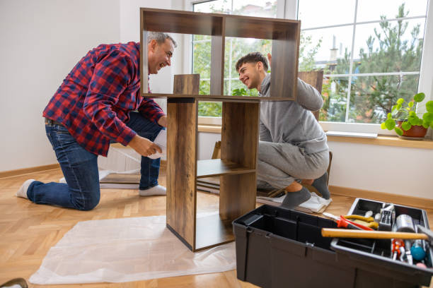 istock Caucasian father and son having fun while assembling shelf in the room 1432342164
