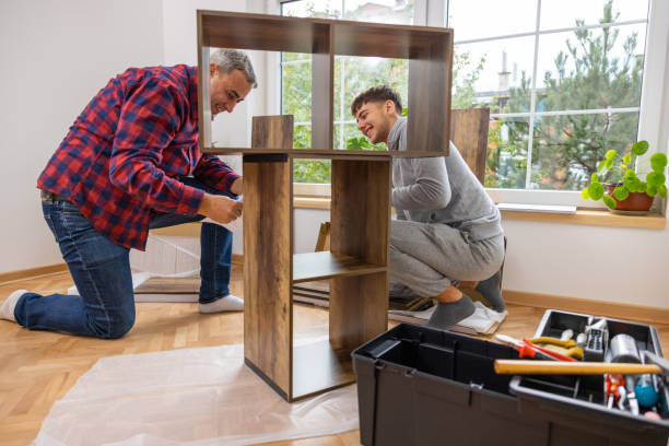 istock Caucasian father and son having fun while assembling shelf in the room 1432342165