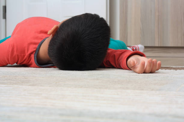 Child lying on the floor at home Dead child lying on the white floor fainted stock pictures, royalty-free photos & images