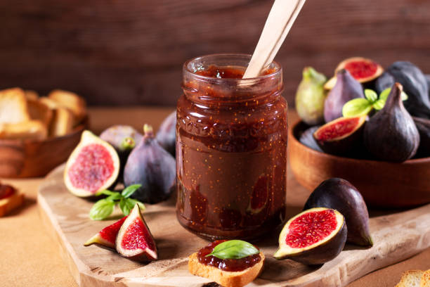 istock Fig jam or fig marmalade on wooden board with fresh, ripe figs 1432342411