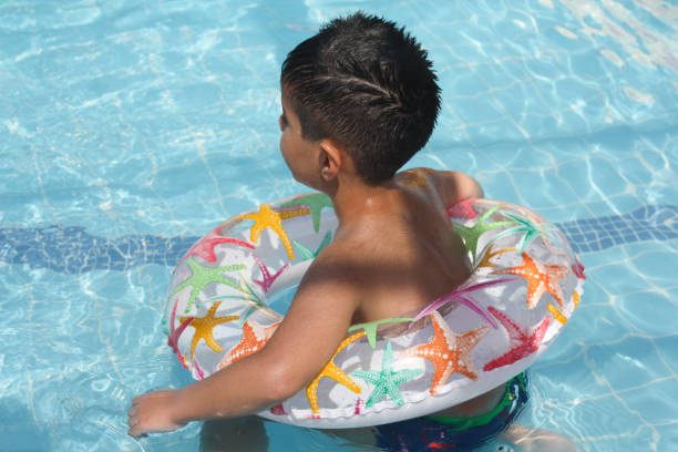 Cute child having fun floating in summer Cross-legged. 