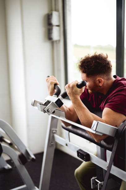 istock athletic young man exercising at a gym. Man doing push-up exercise 1432344524