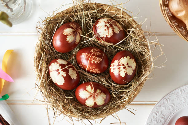 istock Easter eggs dyed with onion peels with a  pattern of herbs in a wicker basket 1432344653