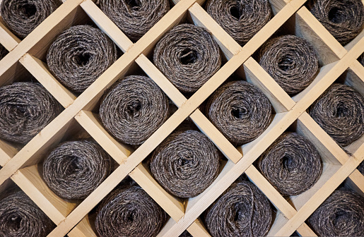 Balls of dark yarn lying in the wooden closet. High quality photo