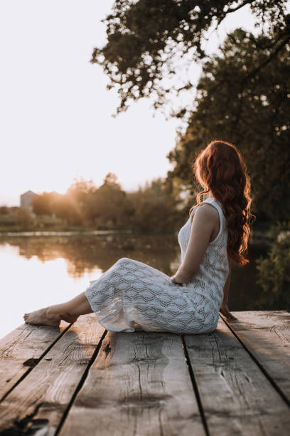 istock Young woman posing by the river. 1432345877