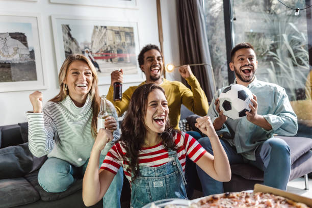 istock Friends at home watching sports match 1432345977
